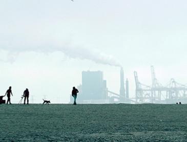 Factory in the background releasing smoke