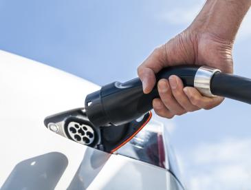 Charging an electric vehicle, shown close up.