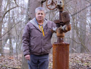  Farmer William Suan with leaking orphan well on his property